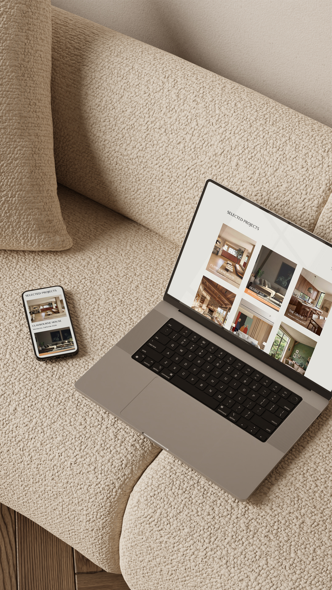 An image of a laptop and phone on a couch with interior design portfolios from Maeten templates on the screens